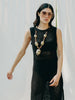 Sassy net knit dress crafted in Switzerland, featuring a classic round neckline, fitting armholes, and stylish side slits, made from organic cotton, perfect for evening wear or summer outings over swimwear